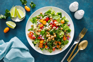 Tabbouleh salad. Tabouli salad with fresh parsley, onions, tomatoes, bulgur and chickpea. Healthy vegetarian food, diet. Top view